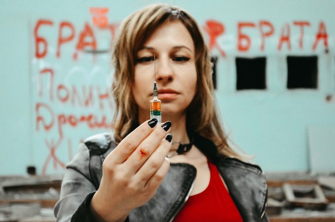 kobieta trzymająca strzykawkę z heroiną
